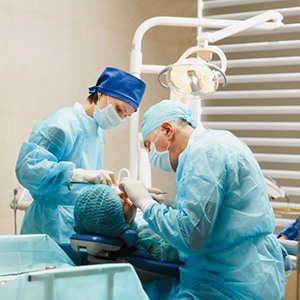 Team performing surgery in patient’s mouth