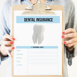 Woman holding clipboard with dental insurance form