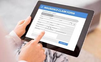 Insurance claim form displayed on electronic tablet