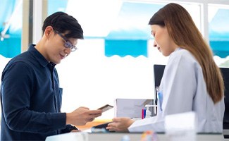 Patient paying for services in dental office