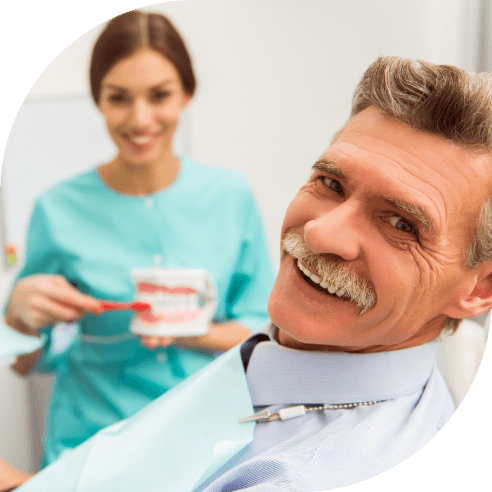 Man with dentures smiling during dental visit