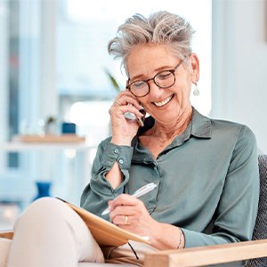 Smiling older woman conversing on phone