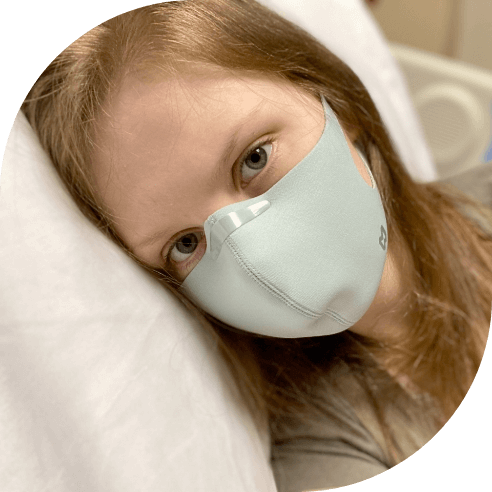 Young chemically sensitive patient wearing a protective face mask