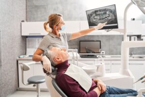 Dentist and patient looking at X-ray